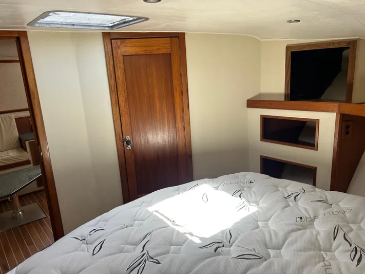 No Slack Yacht Photos Pics Interior cabin of 2002 Albemarle 410 Express Fisherman with bed and wooden accents.