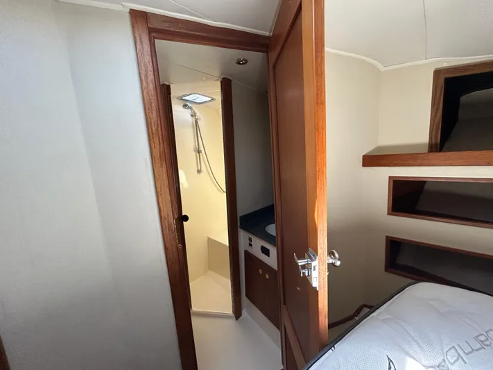 No Slack Yacht Photos Pics 2002 Albemarle 410 Express Fisherman cabin interior with open door to bathroom.