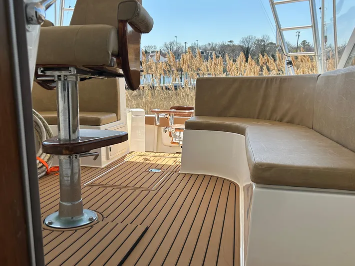 No Slack Yacht Photos Pics 2002 Albemarle 410 Express Fisherman boat interior with cushioned seating and wooden flooring.