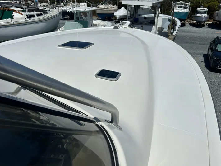 No Slack Yacht Photos Pics 2002 Albemarle 410 Express Fisherman boat deck with hatches, docked among other boats.