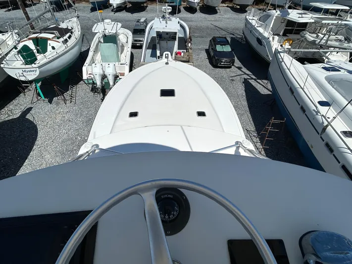 No Slack Yacht Photos Pics 2002 Albemarle 410 Express Fisherman boat in storage yard, surrounded by other vessels.