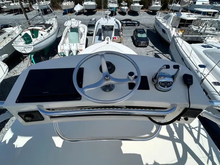 No Slack Yacht Photos Pics 2002 Albemarle 410 Express Fisherman helm with steering wheel and controls, surrounded by boats.