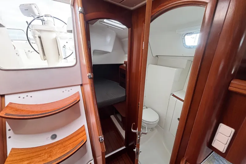 A Domani Yacht Photos Pics Interior of 2002 Beneteau Oceanis 411 yacht showing cabin and bathroom.