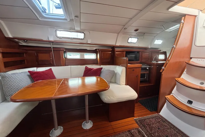 A Domani Yacht Photos Pics Luxurious 2002 Beneteau Oceanis 411 yacht interior with elegant wood finish and cozy seating.