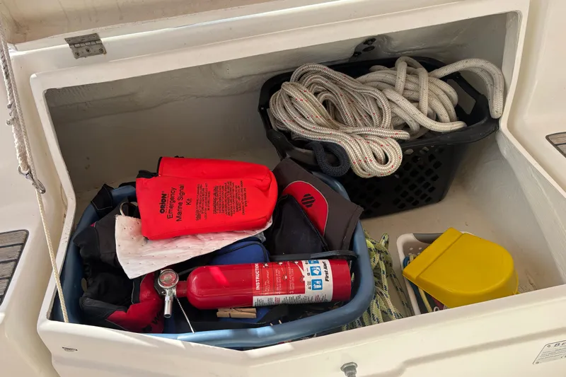 A Domani Yacht Photos Pics Storage compartment on a 2002 Beneteau Oceanis 411 with safety gear and ropes.
