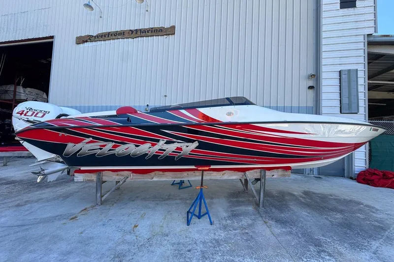  Yacht Photos Pics 2022 Velocity 290sc speedboat with vibrant red and black design at Riverfront Marina.