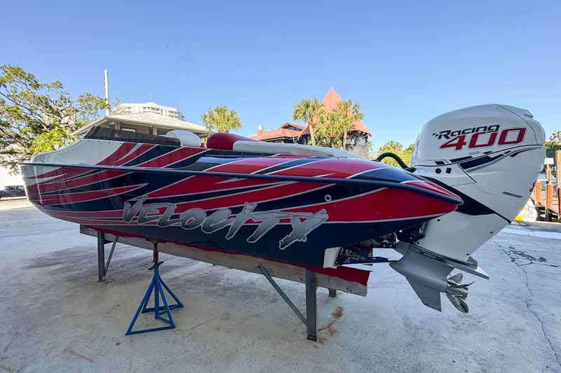  Yacht Photos Pics 2022 Velocity 290sc speedboat with Racing 400 engine, vibrant red and blue design.