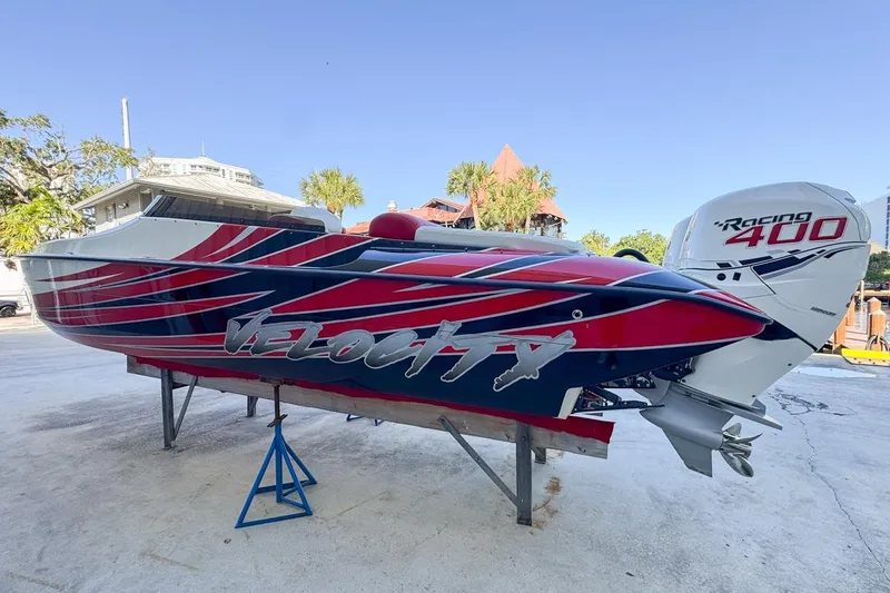  Yacht Photos Pics 2022 Velocity 290sc speedboat with vibrant red and blue design, featuring Racing 400 engine.