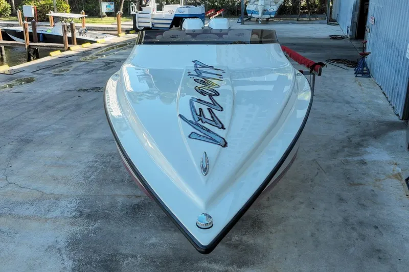  Yacht Photos Pics 2022 Velocity 290sc speedboat docked, showcasing sleek design and bold branding.