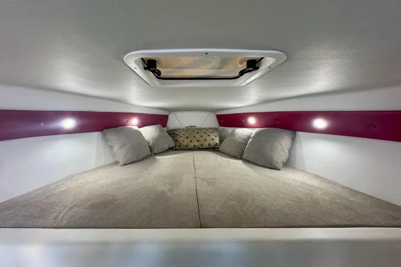 Yacht Photos Pics Cozy interior cabin of 2022 Velocity 290sc with cushions and ambient lighting.