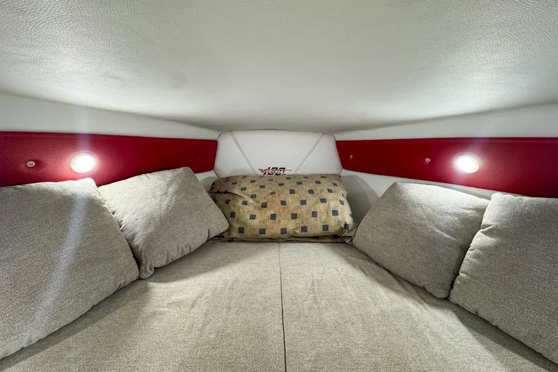  Yacht Photos Pics Cozy interior cabin of 2022 Velocity 290sc boat with cushions and ambient lighting.