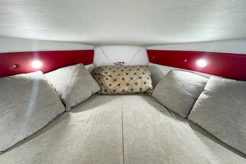  Yacht Photos Pics Cozy interior cabin of 2022 Velocity 290sc boat with cushions and ambient lighting.
