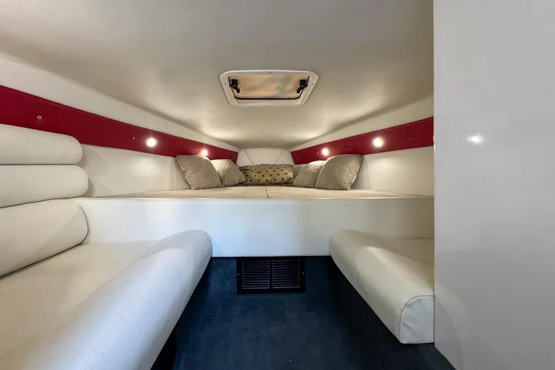 Yacht Photos Pics 2022 Velocity 290sc boat cabin interior with cozy seating and ambient lighting.