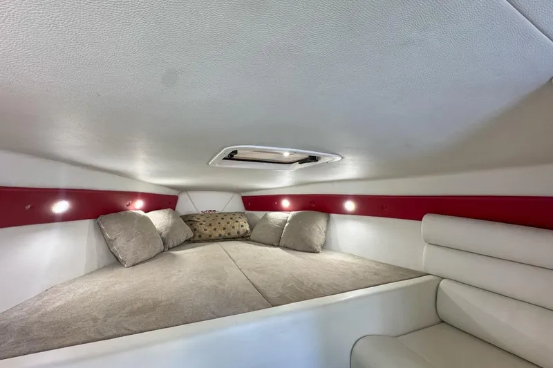  Yacht Photos Pics Cozy interior cabin of 2022 Velocity 290sc boat with cushions and ambient lighting.