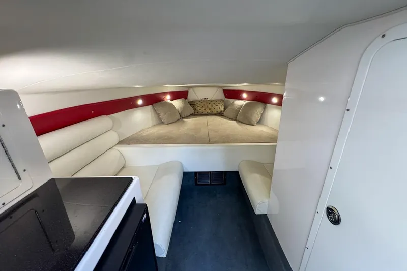  Yacht Photos Pics 2022 Velocity 290sc boat interior with cozy cabin, cushioned seating, and ambient lighting.