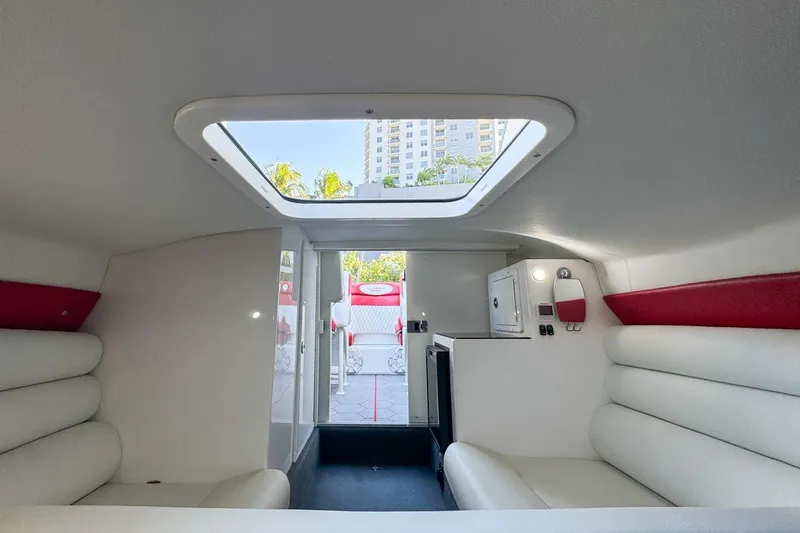  Yacht Photos Pics Interior of 2022 Velocity 290sc boat with white seating and skylight.