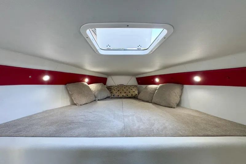  Yacht Photos Pics Cozy interior cabin of 2022 Velocity 290sc boat with skylight and cushions.