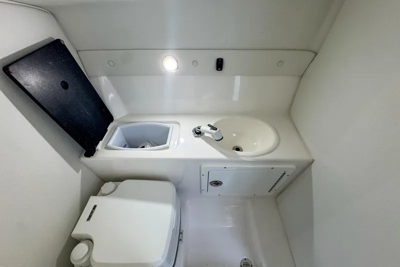  Yacht Photos Pics Compact bathroom in 2022 Velocity 290sc boat with sink and toilet.