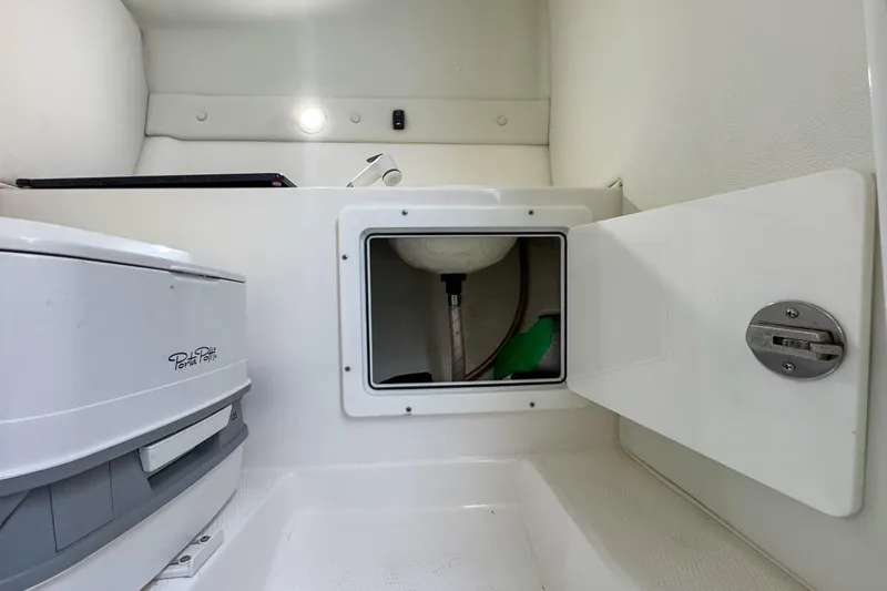 Yacht Photos Pics Interior of 2022 Velocity 290sc boat with Porta Potti and storage compartment.
