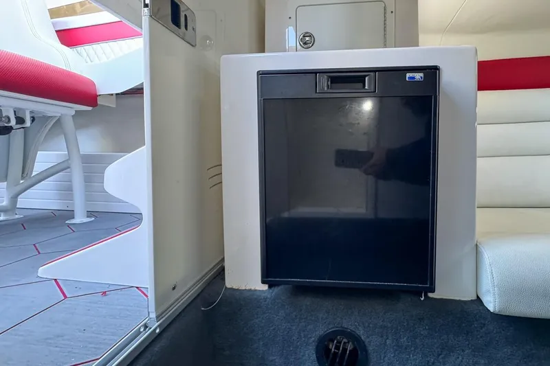  Yacht Photos Pics 2022 Velocity 290sc interior with compact fridge and seating area.