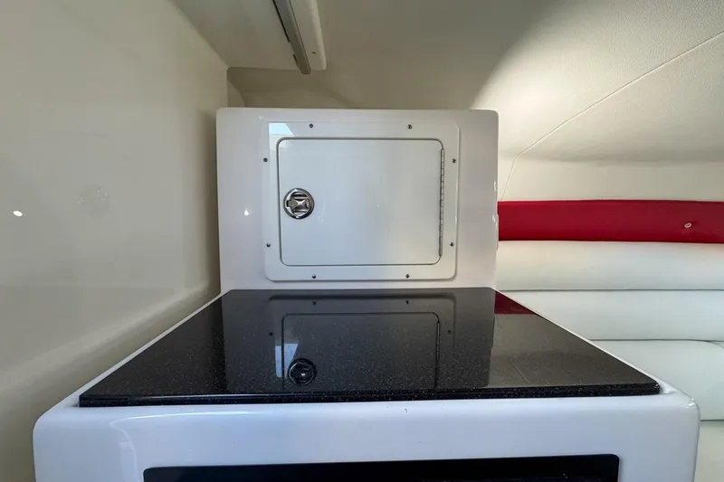  Yacht Photos Pics 2022 Velocity 290sc interior with sleek countertop and storage compartment.