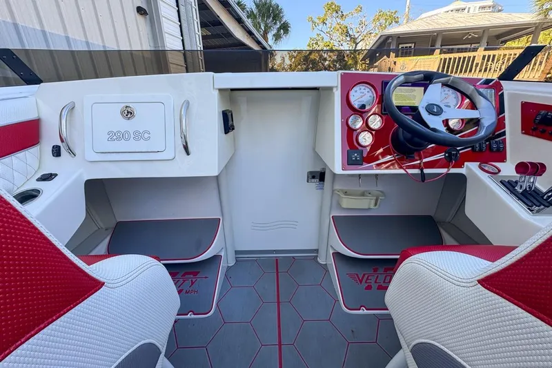  Yacht Photos Pics Interior of 2022 Velocity 290sc boat with red and white seating and control panel.