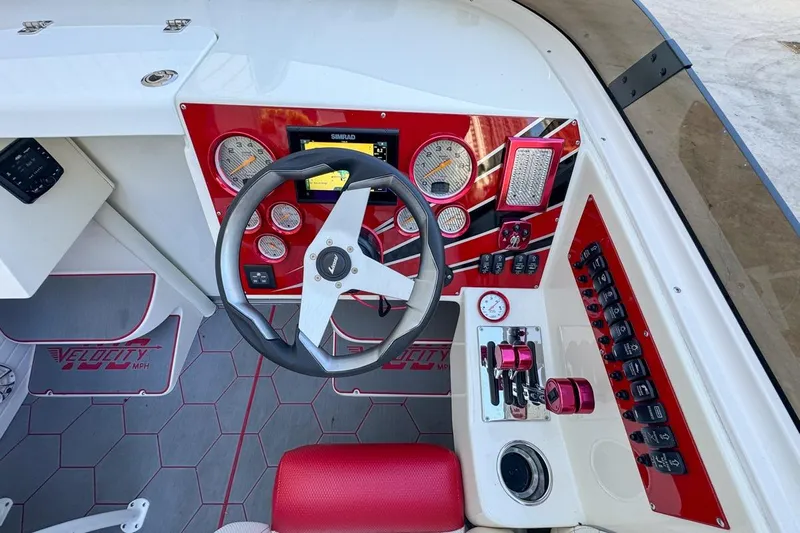  Yacht Photos Pics Cockpit of 2022 Velocity 290sc boat with red accents and modern controls.