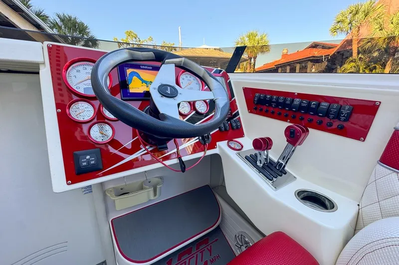  Yacht Photos Pics 2022 Velocity 290sc boat dashboard with steering wheel, gauges, and navigation system.