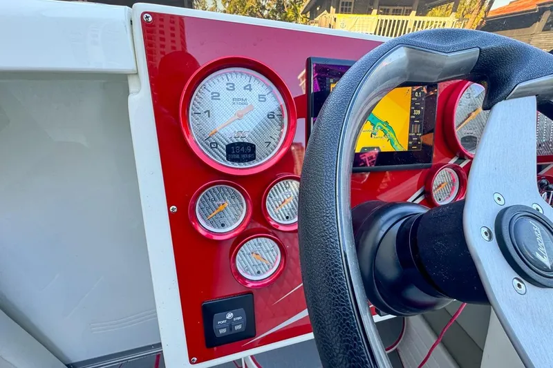  Yacht Photos Pics Dashboard of a 2022 Velocity 290sc boat with gauges and navigation screen.