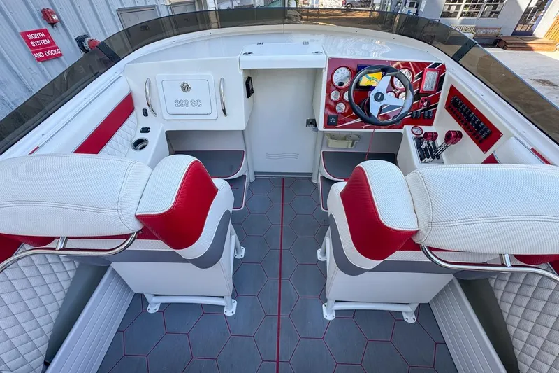  Yacht Photos Pics Interior of a 2022 Velocity 290sc boat with red and white seating and modern dashboard.