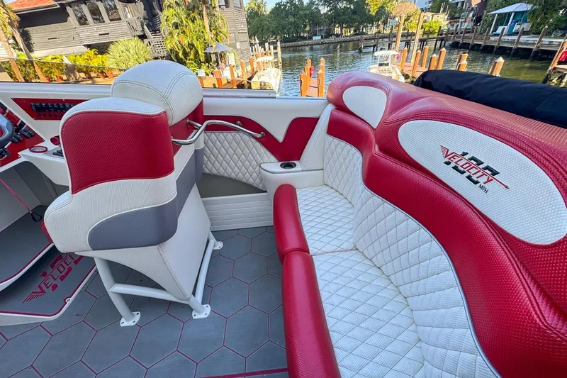  Yacht Photos Pics 2022 Velocity 290sc boat interior with red and white seating, dockside view.
