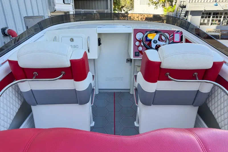  Yacht Photos Pics 2022 Velocity 290sc boat interior with red and white seating, modern dashboard, and steering wheel.
