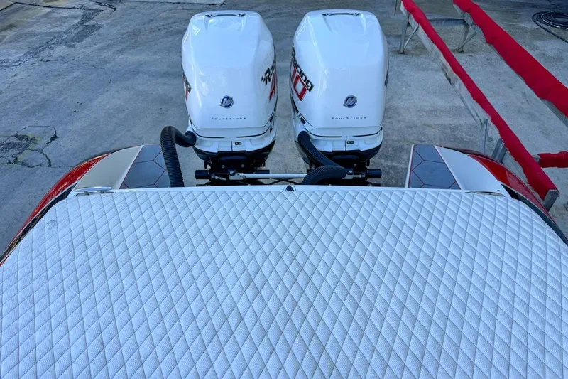  Yacht Photos Pics 2022 Velocity 290sc boat with twin outboard engines, featuring a quilted deck surface.