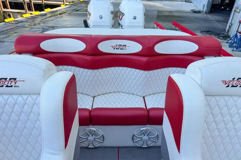  Yacht Photos Pics 2022 Velocity 290sc boat interior with red and white seating, dockside view.