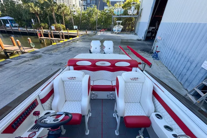  Yacht Photos Pics 2022 Velocity 290sc boat interior with red and white seating, dockside view.