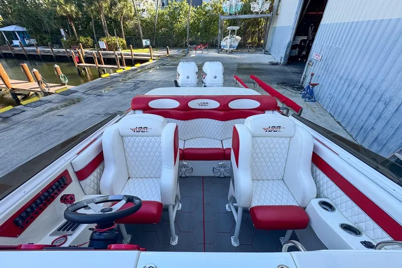 Yacht Photos Pics Interior of 2022 Velocity 290sc boat with red and white seating, dockside view.
