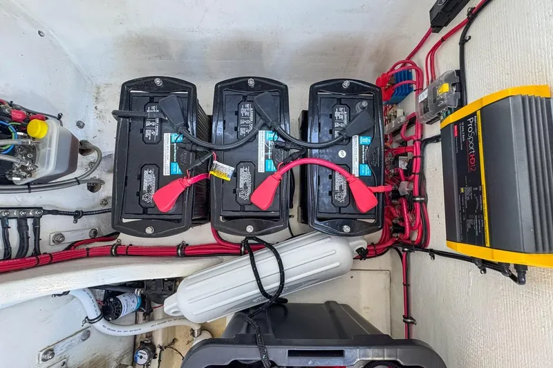  Yacht Photos Pics Battery compartment of 2022 Velocity 290sc boat with wiring and ProSport HD12 charger.