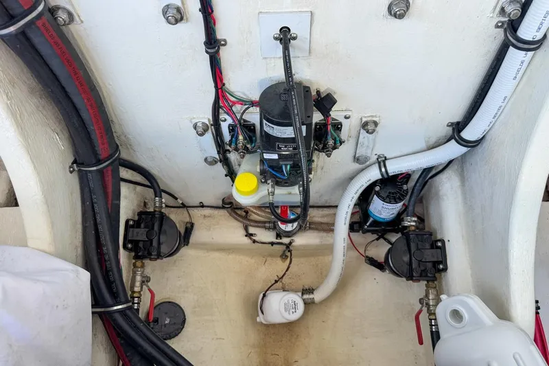  Yacht Photos Pics Engine compartment of a 2022 Velocity 290sc boat, showcasing wiring and components.