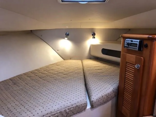 Good Fun Yacht Photos Pics 2006 Pursuit 3370 Offshore cabin interior with cozy bedding and ambient lighting.