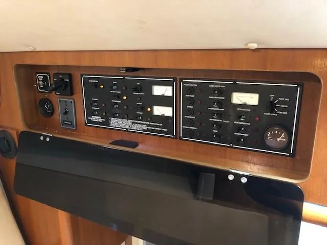 Good Fun Yacht Photos Pics Control panel of a 2006 Pursuit 3370 Offshore boat, featuring various switches and gauges.