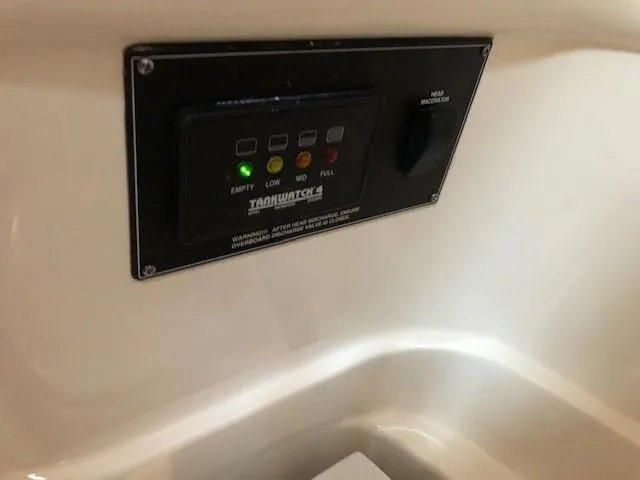 Good Fun Yacht Photos Pics Control panel of a 2006 Pursuit 3370 Offshore boat, featuring tank level indicators.