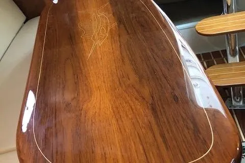 Good Fun Yacht Photos Pics Polished wooden table with marlin engraving on 2006 Pursuit 3370 Offshore boat.
