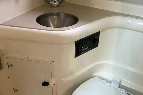 Good Fun Yacht Photos Pics 2006 Pursuit 3370 Offshore boat bathroom with sink and toilet.