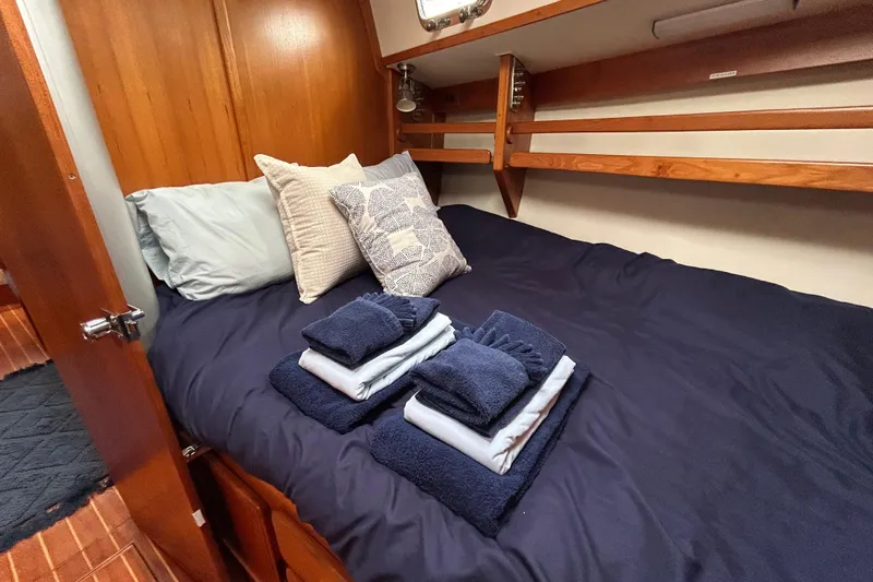 Harriet Tubman Yacht Photos Pics Cozy cabin interior of 2002 Caliber 40 yacht with neatly arranged bedding and towels.