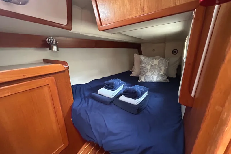 Harriet Tubman Yacht Photos Pics Cozy cabin interior of 2002 Caliber 40 sailboat with neatly arranged bedding.