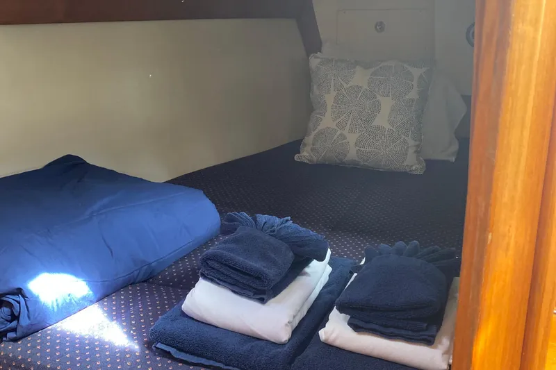 Harriet Tubman Yacht Photos Pics Cozy cabin interior of 2002 Caliber 40 sailboat with neatly arranged towels and cushions.
