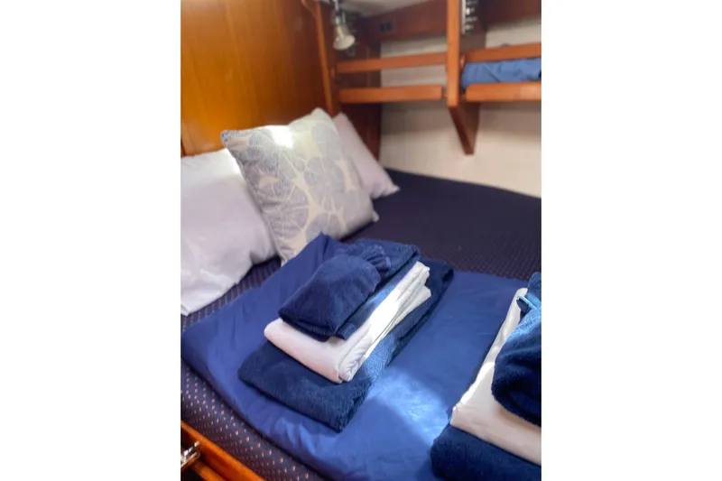Harriet Tubman Yacht Photos Pics Cozy cabin bed in 2002 Caliber 40 yacht with neatly folded blue and white linens.