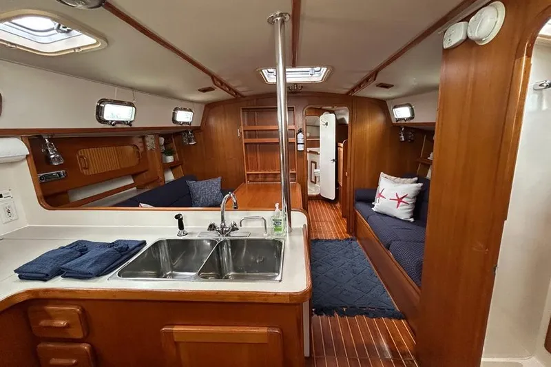 Harriet Tubman Yacht Photos Pics Interior of a 2002 Caliber 40 sailboat with wood finish and cozy seating.
