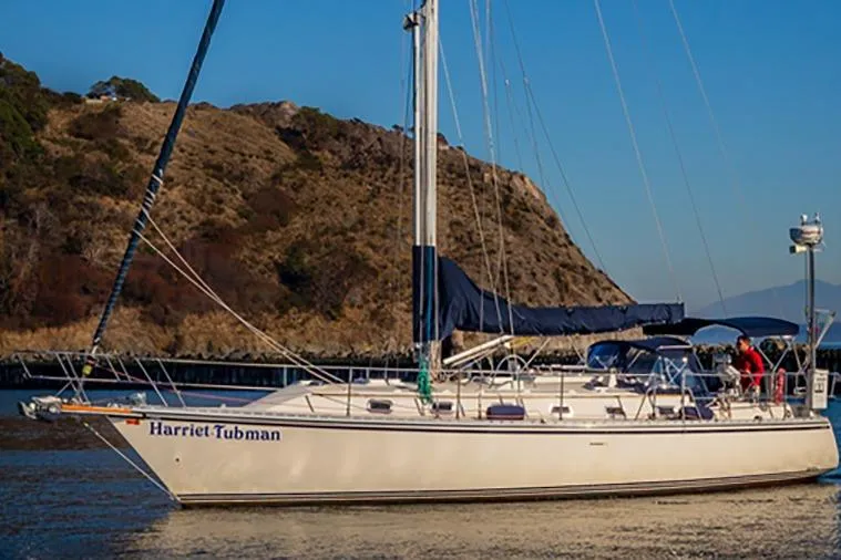Harriet Tubman Yacht Photos Pics Sailboat "Harriet Tubman," Caliber 40, 2002 model, anchored near rocky shoreline.