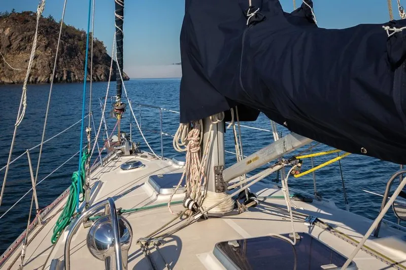 Harriet Tubman Yacht Photos Pics Sailing yacht Caliber 40, 2002 model, cruising near rocky coastline.